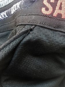 closeup of loose threads in saxx shorts
