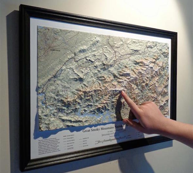 GSMNP Trail Map Black Frame on Wall with hand
